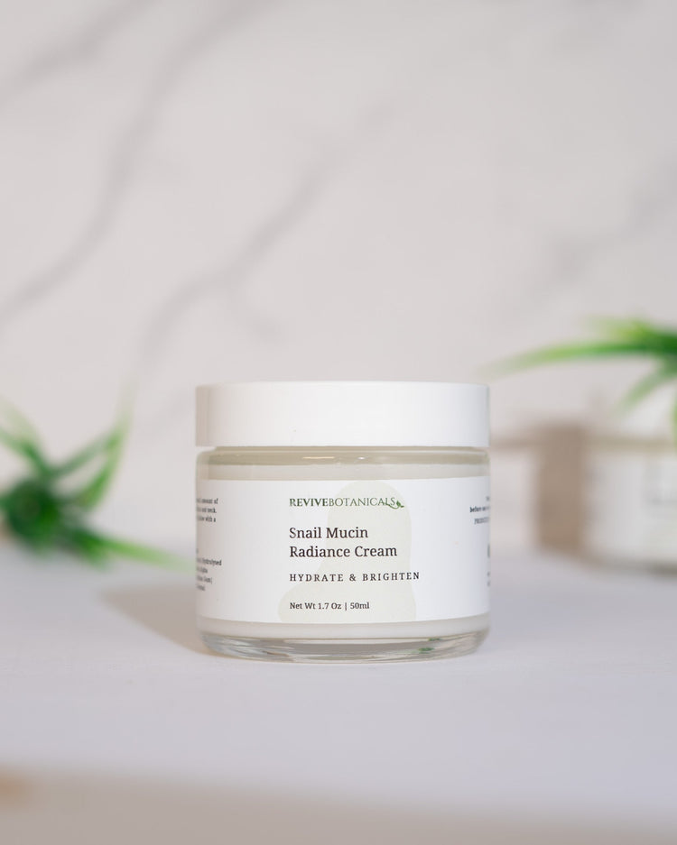 Snail Mucin Radiance Cream in a white jar with a minimalistic design for hydrated and radiant skin.