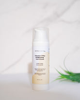 Vitamin C Plus Brightening Face Cream bottle on a marble surface.