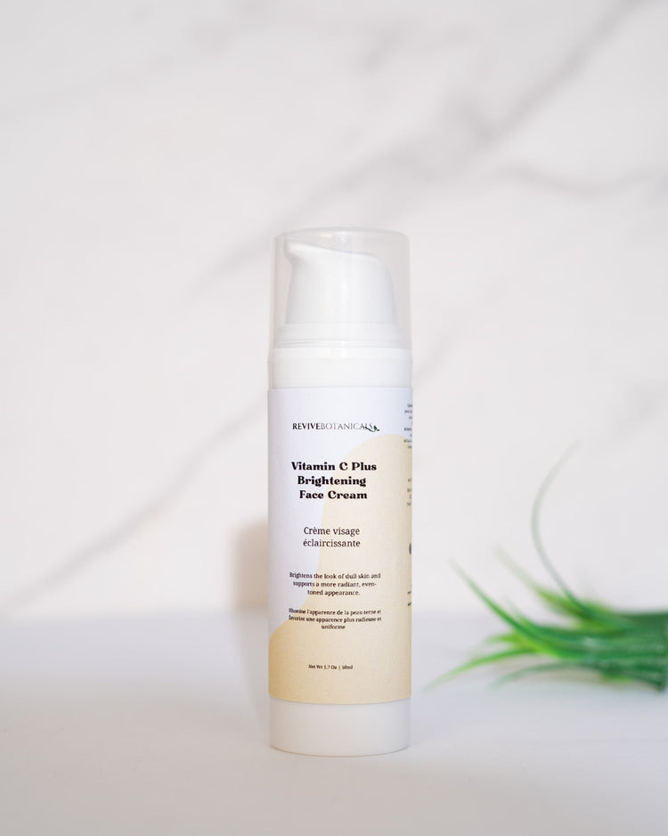 Vitamin C Plus Brightening Face Cream bottle on a marble surface.