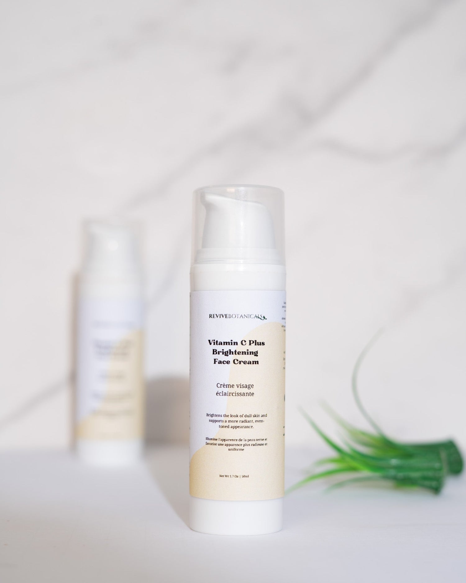 Vitamin C Plus Brightening Face Cream bottle on a marble surface.